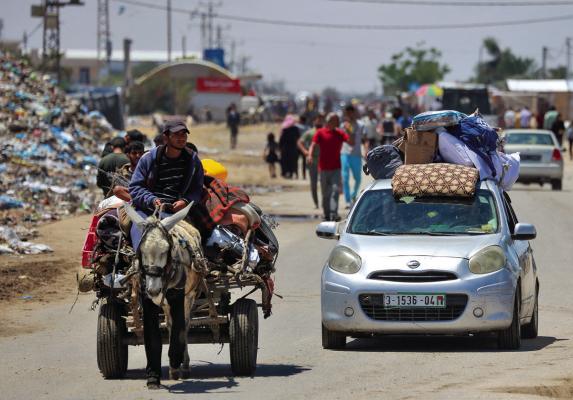 DISPLACED PALESTINIANS who left with their belongings from Rafah in the southern Gaza Strip following an evacuation order by the Israeli army, arrive to Khan Yunis on May 6, 2024, amid the ongoing conflict between Israel and the Palestinian Hamas movement. (-/AFP via Getty Images/TNS)
