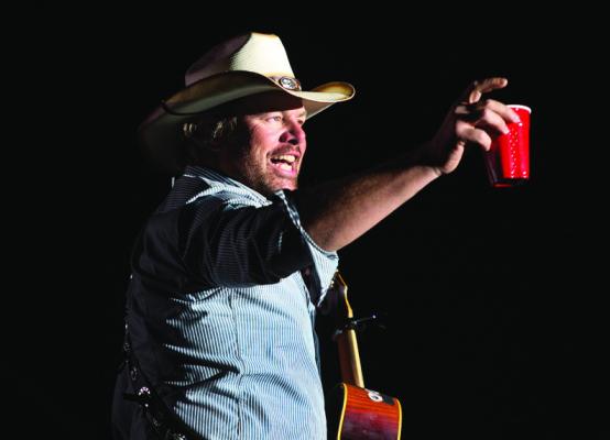 TOBY KEITH toasts his fans with a red Solo cup, the name of one of his hit songs, during the Stagecoach Festival on April 26, 2013, in Indio, California. (Allen J. Schaben/Los Angeles Times/TNS)