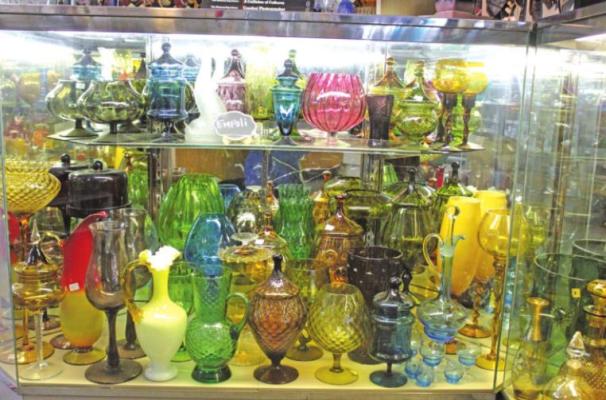 Assorted glassware, including several vases and candelabras for sale. Photo by Calley Lamar.