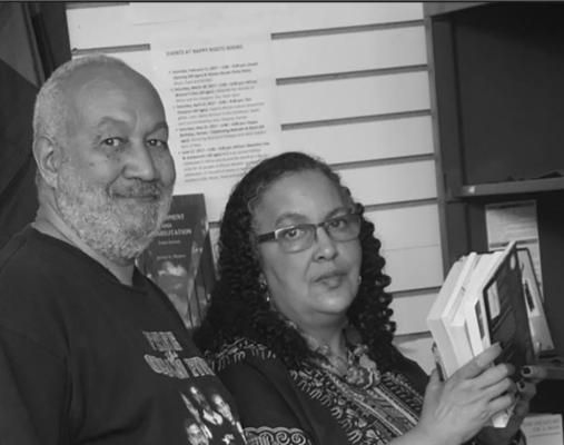 Camille Landry and Banbose Shango, owners, stock books in their store. (Photo provided by Camille Landry)