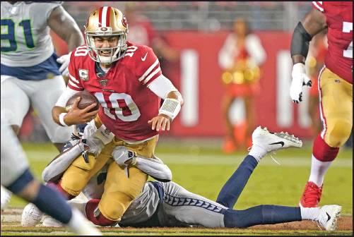 SAN FRANCISCO 49ers quarterback Jimmy Garoppolo (10) is sacked by Seattle Seahawks cornerback Tre Flowers during the first half of an NFL game in Santa Clara, Calif., Monday. Seattle won 27-24 in overtime to give the 49ers their first defeat. (AP Photo)
