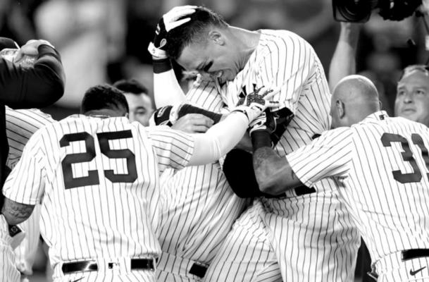 Aaron Judge (99) of the New York Yankees is congratulated by teammates after hitting a walk-off home run against the Kansas City Royals during the ninth inning at Yankee Stadium on July 28, 2022, in New York City. The Yankees won 1-0. (Adam Hunger/ Getty Images/TNS)