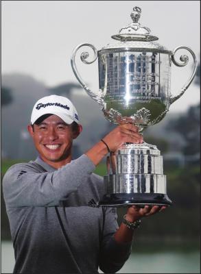 COLLIN MORIKAWA holds the Wanamaker Trophy after winning the PGA Championship golf tournament at TPC Harding Park Sunday, Aug. 9, 2020, in San Francisco. (AP Photo/Jeff Chiu)