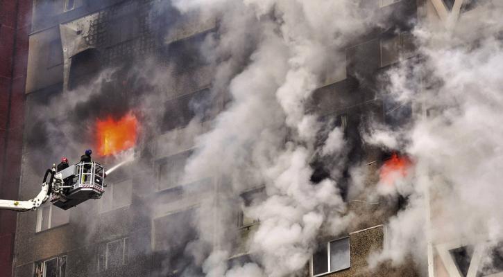 UKRAINIAN RESCUERS extinguish a fire in a residential building following a missile attack in Kyiv on Feb. 7, 2024, amid the Russian invasion of Ukraine. At least three people were killed in a “massive” wave of Russian missile and drone attacks across Ukraine early on Feb. 7, 2024, President Volodymyr Zelensky said. (Sergei Supinsky/AFP via Getty Images/TNS)