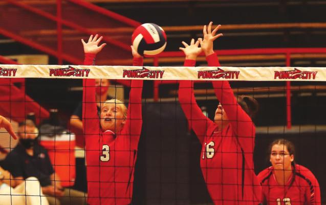 GOING HIGH at the net are Ponca City junior varsity volleyball blockers Erin Parent (3) and Anna Siemers (16) during action Monday against Stillwater at Robson Field House. It was the first official action of the year for Ponca City’s Lady Cats. This photo was provided by Larry Williams.