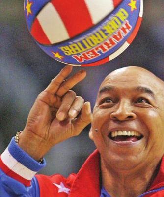 FRED “CURLY” Neal of the Harlem Globetrotters performs during a timeout in a 2008 NBA basketball game between the Indiana Pacers and the Phoenix Suns in Phoenix. Neal, the dribbling wizard who entertained millions with the Harlem Globetrotters for parts of three decades, has died the Globetrotters announced Thursday. He was 77. (AP Photo)