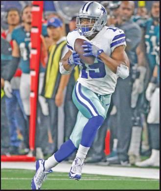 DALLAS COWBOYS wide receiver Amari Cooper (19) catches a long pass in the first half of an NFLgame against the Philadelphia Eagles in Arlington, Texas, Sunday. The Cowboys won 37-10. (AP Photo)