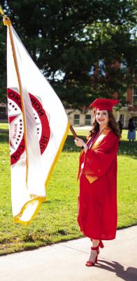 NOC’S EMMA VALGORA carries the NOC Institutional Flag at Commencement Exercises last Saturday. (photo by Shiloh Martin/ Northern Oklahoma College)