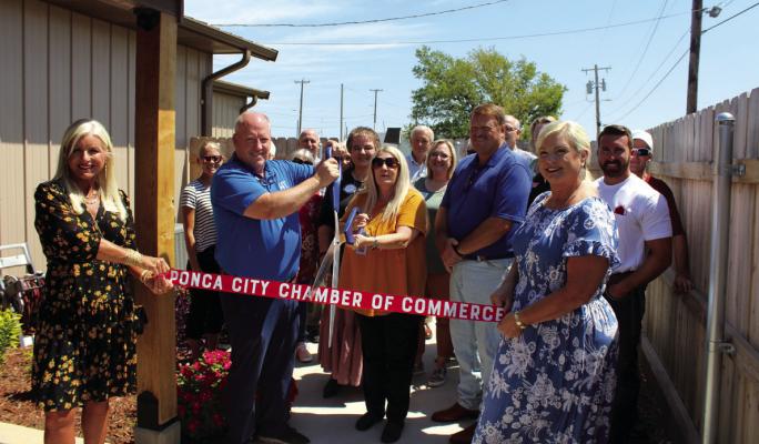 A RIBBON cutting ceremony was held for the Rotary Garden project at Golden Villa Adult Day Services Center on Monday, Aug. 28. Cutting the ribbon are Richard Winterrowd, president of Ponca City Rotary from 2019 to 2020, and Golden Villa Executive Director Lisa Hockenbury. Holding the ribbon are rotarians Shelley Arrott and Tiffany Hermann. (Photo by Calley Lamar)