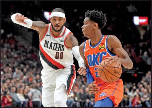 OKLAHOMA CITY Thunder guard Shai Gilgeous-Alexander, right, drives to the basket on Portland Trail Blazers forward Carmelo Anthony, left, during an NBA game in Portland, Ore., Sunday. (AP Photo)