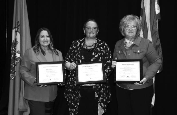KAY COUNTY Deputy Clerk Dawn Alexandersen is congratulated after receiving her certificates for attaining Basic, Advanced I, and Advanced II certifications for County Clerks from the OSU County Training Program (CTP) by SA&amp;I County Management Service Cheryl Wilson and SA&amp;I Public Audits Nancy Grantham. (Photo provided)