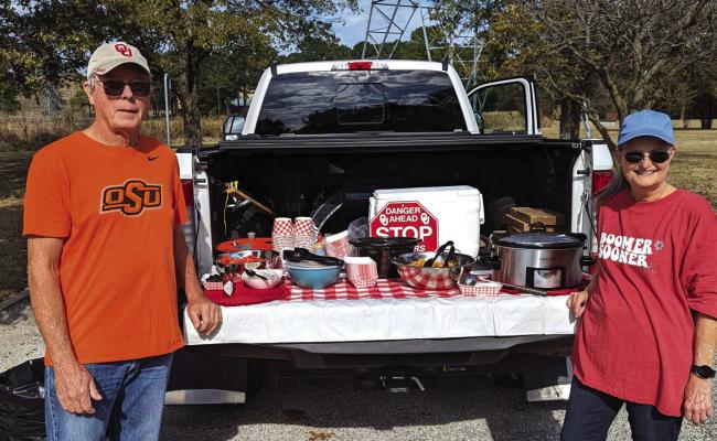 SERVING AT their tailgate are Ponca City members Terry and Vicki Blevins. Photos provided