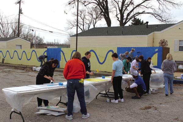 On Wednesday, March 15, a group had volunteers came out to Dearing House from 10 am to 2 pm to update the colors on their north fence. The fence was last decorated in 2019, and is now painted blue with geometric shapes in various bright colors. (Photo by Calley Lamar)