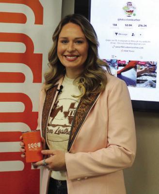 THE MONTHLY 1 Million Cups meeting was held at Pioneer Technology Center on Wednesday, Dec. 6 in the cafeteria atrium. The speaker for the meeting was Taylor Huber (pictured), who shared information about her business: TD Custom Leather. Huber was presented with an orange cup, an item given to all speakers at 1 Million Cups. (Photo by Calley Lamar)