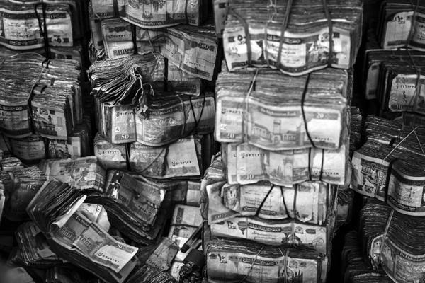 Stacks of worn out Afghan currency sit in organized piles, ready to be exchange at the Sarai Shahzadah, Kabul’s currency exchange market in Kabul, Afghanistan, Saturday, Sept. 10, 2022. (Marcus Yam/Los Angeles Times/TNS)