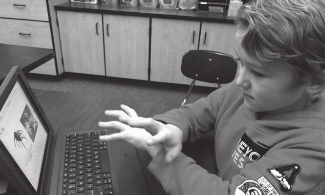 Adrian Marley, an Oklahoma School for the Deaf third grader from Blanchard, uses AvePM software apps to improve his language skills.