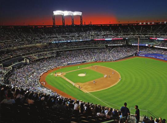 IN THIS AUG. 29, 2019, file photo, the sun sets behind Citi Field during a baseball game between the New York Mets and the Chicago Cubs in New York. Major League Baseball players ignored claims by clubs that they need to take additional pay cuts, instead proposing they receive a far higher percentage of salaries and a commit to a longer schedule as part of a counteroffer to start the coronavirus-delayed season. (AP Photo/Kathy Willens, File)