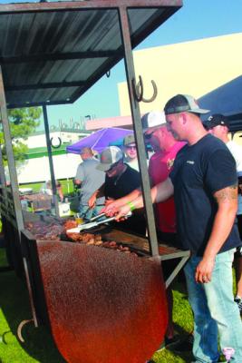 The Firefighters of Ponca City enjoy a game of friendly competition for grillmaster, voted on by the guests in attendance. (Photo by Dailyn Emery