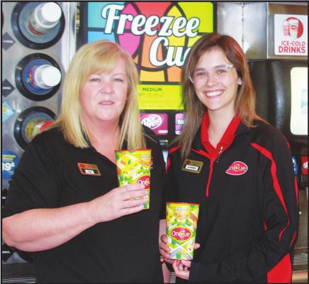 ONCUE MANAGER Lisa Anderson and first assistant manager Summer Parks pose with cups being sold to support Ponca City Public Schools. (News Photo by Jessica Windom)