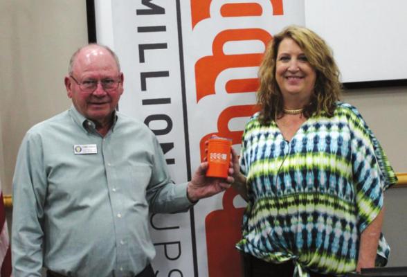Lotus Acupuncture was the May speaker at the 1 Million Cups meeting held on Wednesday, May 4. Dr. Robert Howard (left) presented an orange cup to speaker Dr. Nancy Tegan. (Photo by Calley Lamar)