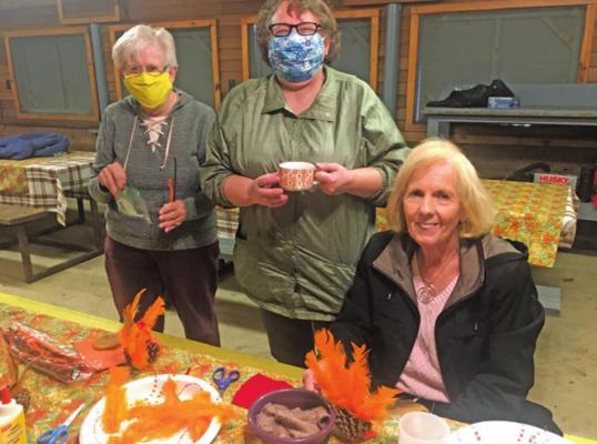 Clarice Olsen, Rebecca Blakeburn, and Vie Bottger display their Thanksgiving turkeys made as holiday decorations during the November Wheeler Dealers campout.