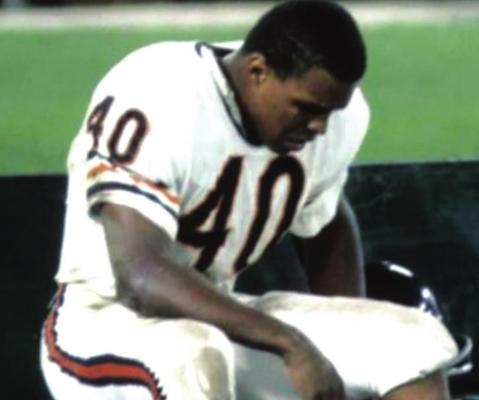 GALE SAYERS sits on the Chicago Bears bench after an injury. Sayers’ illustrious career was cut short by a series of serious knee injuries.