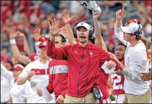 OKLAHOMA HEAD coach Lincoln Riley cheers with his players and coaches during a football game against Baylor for the Big 12 Conference championship, Saturday in Arlington, Texas. The Sooners won in overtime and will participate in the College Football Playoffs as the No. 4 seed. (AP Photo)