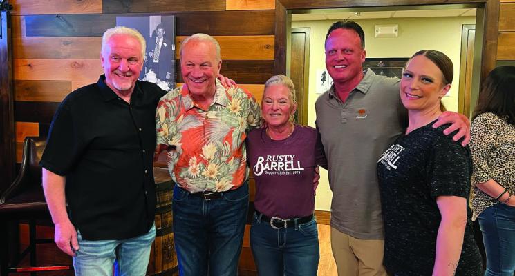 FORMER OKLAHOMA Sooner football Coach Barry Switzer, second from left, was at the Rusty Barrell in Ponca City Tuesday night. Switzer won three national championships while coaching at Oklahoma and he went on to coach the Dallas Cowboys to a Super Bowl XXX victory. He has been retired from coaching since 1997. Photo by Frank Leto.
