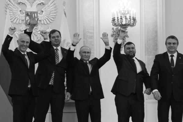 (L-R) The Moscow-appointed heads of Kherson region Vladimir Saldo and Zaporizhzhia region Yevgeny Balitsky, Russian President Vladimir Putin, Donetsk separatist leader Denis Pushilin and Lugansk separatist leader Leonid Pasechnik react after signing treaties formally annexing four regions of Ukraine Russian troops occupy, at the Kremlin in Moscow on September 30, 2022.