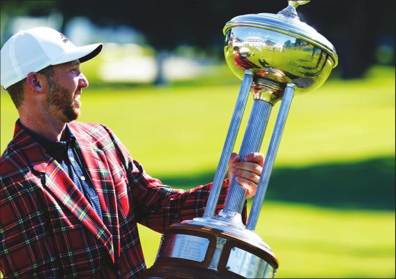 DANIEL BERGER poses with the championship trophy after winning the Charles Schwab Challenge golf tournament after a playoff round at the Colonial Country Club in Fort Worth, Texas, Sunday, June 14, 2020. (AP Photo/David J. Phillip)