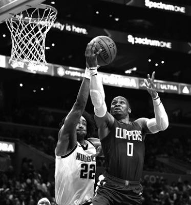 RUSSELL WESTBROOK (0) of the Los Angeles Clippers takes a shot against Zeke Nnaji (22) of the Denver Nuggets in the second quarter at Crypto.com Arena on Monday, Nov. 27, 2023, in Los Angeles. (Ronald Martinez/Getty Images/TNS)