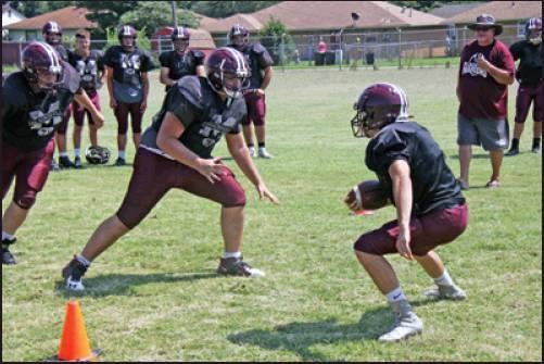 MEMBERS OF the Blackwell Maroons football team participate in a tackling drill during a practice session Monday in Blackwell. The Maroons will open their season Sept. 30 when they travel to Tonkawa to play the defending Class A state champion Buccaneers. (News Photo by David Miller)