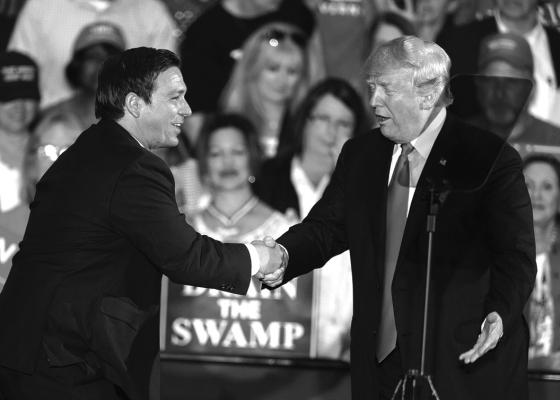 U.S. PRESIDENT Donald Trump welcomes Florida gubernatorial candidate Ron DeSantis to the stage at a campaign rally at the Pensacola International Airport on Nov. 3, 2018, in Pensacola, Florida. (Mark Wallheiser/Getty Images/TNS)