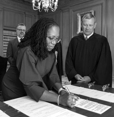 Chief Justice John G. Roberts Jr. looks on as Justice Ketanji Brown Jackson signs the Oaths of Office. (Fred Schilling/Collection of the Supreme Court of the United States via Getty Images/TNS)