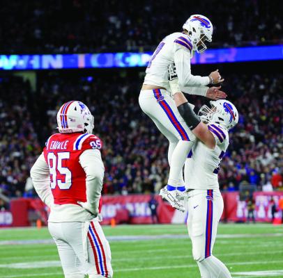 Hunter Henry of the New England Patriots watches as Josh Allen, left, of the Buffalo Bills celebrates his touchdown throw with Spencer Brown during the first half of Buffalo’s 24-10 victory Thursday night, Dec. 1, 2022, in Foxboro, Massachusetts. (Matt Stone/Boston Herald/TNS)