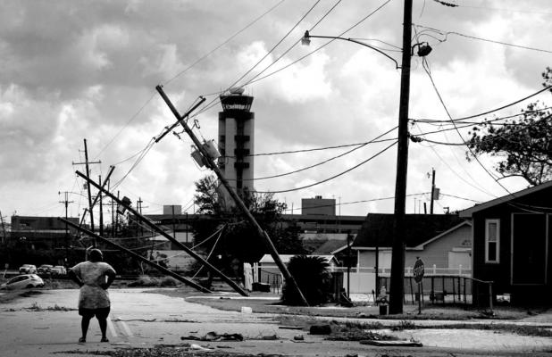 A woman looks over damage to a neighborhood caused by Hurricane Ida on Monday, August 30, 2021 in Kenner, Louisiana. Ida made landfall yesterday as a Category 4 storm southwest of New Orleans. (Scott Olson/Getty Images/TNS)