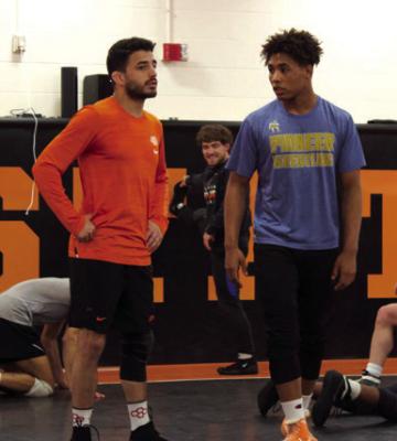 Luke Tolbert Cowboy Wrestling Club coach Zoheir El-Ouarraqe (left) moved from France several years ago and assists young wrestlers in achieving their Olympic goals.