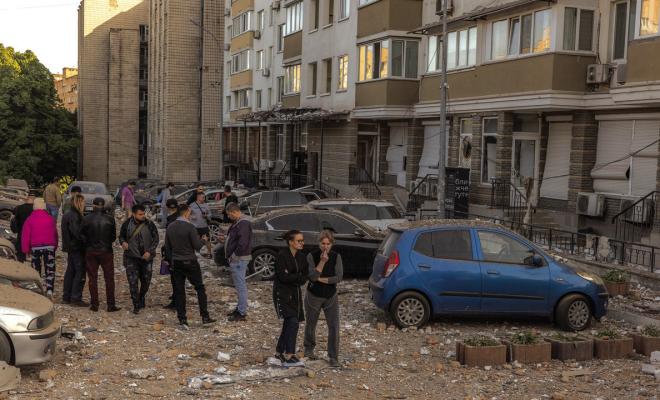 RESIDENTS GATHER at the site where an apartment building was hit during Russian drone attacks on May 30, 2023, in Kyiv, Ukraine. The capital Kyiv got under a third Russian air attack in 24 hours. At least one person was killed in an early Tuesday strike, the Kyiv mayor said. (Roman Pilipey/Getty Images/TNS)
