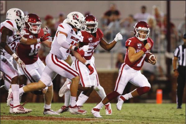 IN THIS Sept. 7, 2019 file photo, Oklahoma quarterback Spencer Rattler (7) carries in the fourth quarter of an NCAA college football game against South Dakota, in Norman, Okla. The coronavirus pandemic has shut down much of Division I football, but with three of the Power Five leagues still playing, there are still some big games to look forward to. Oklahoma takes on Texas on Oct. 10, 2020. (AP Photo/Sue Ogrocki, File)