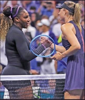 SERENA WILLIAMS, left, shakes hands with Maria Sharapova after their first-round match at the U.S. Open tennis tournament in New York,Monda . Williams won. (AP Photo)