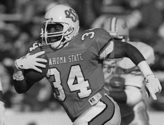THURMAN THOMAS carries the ball during a game he played at Oklahoma State. Thomas had a great game in the 1987 Sun Bowl game against West Virginia. Thomas went on to a great career in the NFL playing for the Buffalo Bills. OSU defeated West Virginia 35-33 in the bowl game.