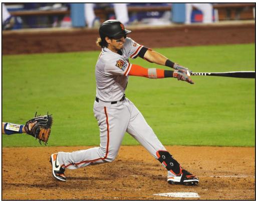 SAN FRANCISCO Giants’ Mauricio Dubon hits an RBI single during the sixth inning of a baseball game against the Los Angeles Dodgers, Sunday, July 26, 2020, in Los Angeles. (AP Photo/Jae C. Hong)