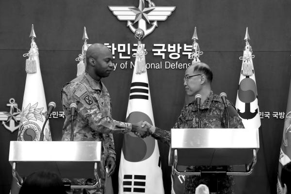 From left, Col. Isaac Taylor of the United Nations Command, Combined Forces Command, and United States Forces Korea, shakes hands with Col. Lee Sung-jun of South Korea’s Joint Chiefs of Staff during a news briefing on the Freedom Shield Exercise at the Defense Ministry on Friday, March 3, 2023, in Seoul, South Korea. (Chung Sung-Jun/Getty Images/TNS)