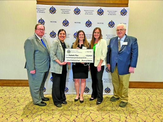 MARLAND’S PLACE staff members Ally Broome (center) and Caitlin Clark (right of Broome) with board President Casey Pruitt (left of Broome) accepted a $145,000 grant from the Masonic Charity Foundation of Oklahoma to support campus revitalization efforts. (Photo Provided)