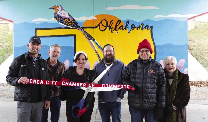 A ribbon cutting was held for the underpass mural at the underpass on Hartford Ave. under the Union Street bridge. Pictured from left to right are Bobby Garrett of Mid-Con Energy Services, Traffic Engineering Manager Mike Lane, Theresa Sacket, Jeremy Sacket, Carl Renfro, Brenda Renfro. (Photo by Calley Lamar)