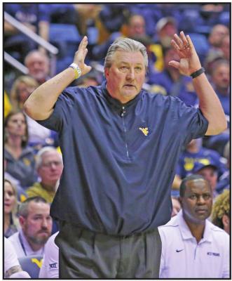 WEST VIRGINIA coach Bob Huggins reacts to a call during his team’s college basketball game against Oklahoma State on Tuesday in Morgantown, W.Va. West Virginia won 65-47 to give Huggins his 879th career victory. (AP Photo)
