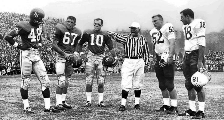 IN THIS University of Nebraska photo, Sid Micek (10), Gale Sayers (48) and another KU player meet with representatives of the Nebraska Cornhuskers at a pregame coin toss. Kansas had the better team in this era.
