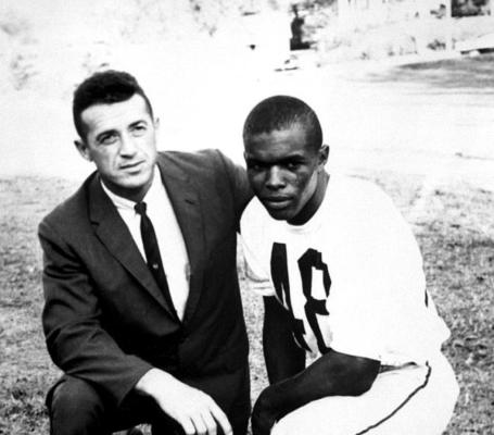 JACK MITCHELL was the coach of the Kansas football team during Sid Micek’s tenure there. Here Mitchell is shown with Gale Sayers, his All-American running back. Mitchell was a quarterback for Bud Wilkinson’s Oklahoma Sooners during his college days.