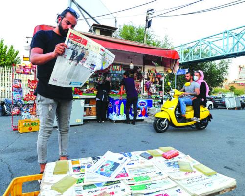 A man reads the Iranian newspaper Etemad, with the front page title reading in Farsi “The night of the end of the JCPOA,” and cover photos of Iran’s Foreign Miniser Hossein Amir-Abdollahian and his deputy and chief nuclear negotiator Ali Bagheri Kani, in the capital Tehran, on Tuesday, Aug. 16, 2022. (Atta Kenare/AFP/ Getty Images/TNS)