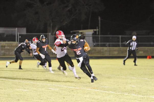 Ryan Morgan (2) runs to the clear with a stiff arm. (Photo by Jacquelyn Heinrich)